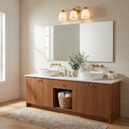 This Clérachic bar sconce in brass finish hangs above a mirror over a double vessel-sink vanity in wood.