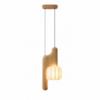 This light wood, vertical-style Clérachic pendant appears here in studio, its tall curved arm topped with a glowing shade.