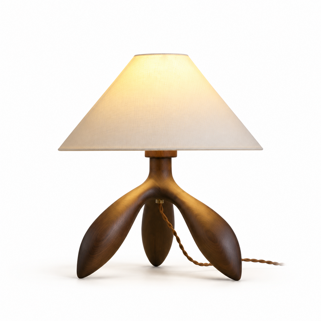 Another studio angle of this Clérachic lamp in dark wood, showing its three curved tripod legs and braided cord.