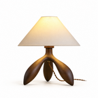 Another studio angle of this Clérachic lamp in dark wood, showing its three curved tripod legs and braided cord.