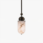 Close view of a single Clérachic pendant capsule, its marbled alabaster shade glowing warm beneath a sphere joint and finial.