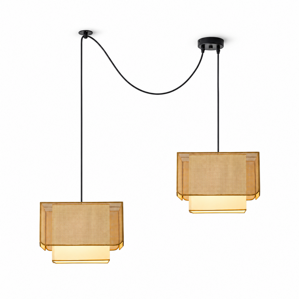 Shown from another angle, two of these Clérachic pendants swag from black ceiling plates, both glowing warm.
