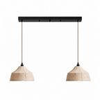 Two faceted woven Clérachic pendants hang from a black linear ceiling plate on a plain background.