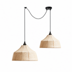 These two faceted woven Clérachic pendants hang at uneven heights, with cords crossing on a plain background.