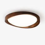 Walnut flush mount ceiling light glowing softly in a modern room