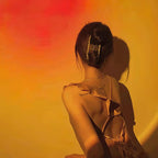 A sunset glow from this Clérachic projection lamp washes orange and red light across a woman's bare shoulders and back.