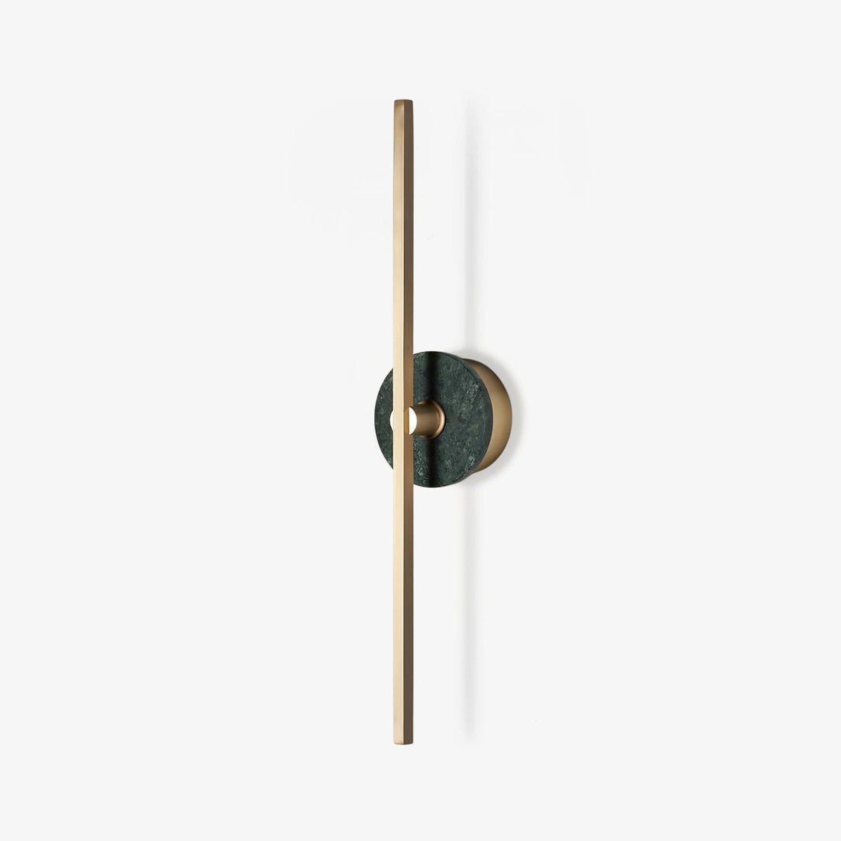 Clérachic wall sconce photographed alone on white, a slim brass bar crossed by a small green stone disc partway up.