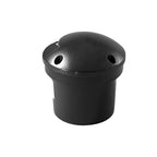 The unlit light on white, its plain black dome and two side openings above the buried canister.