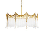 Multi-light copper chandelier with clear glass shades suspended in a bright interior
