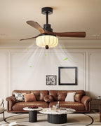 Over a leather sofa and round marble coffee tables, this Clérachic ceiling fan's walnut blades and softly lit lantern shade furnish the living room.