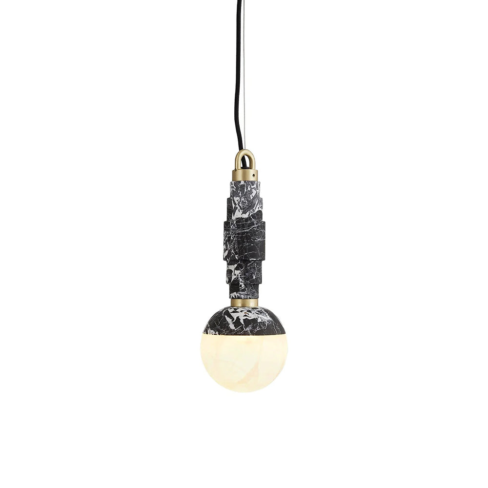 The pendant lit on a white background, warm light glowing through the translucent alabaster globe.