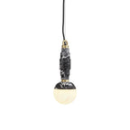 The pendant lit on a white background, warm light glowing through the translucent alabaster globe.