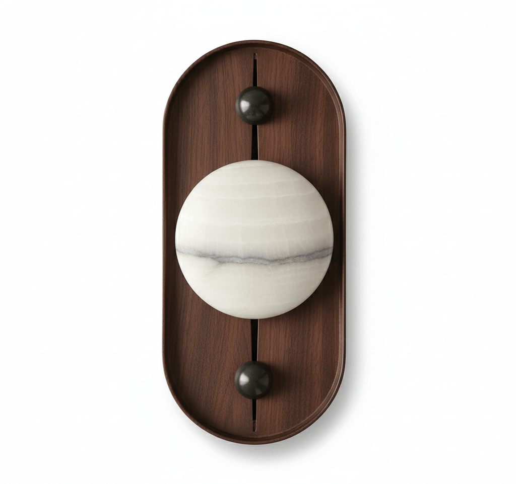 The oval Koyan wall light unlit, its alabaster globe crossed by a grey mineral band, on white.