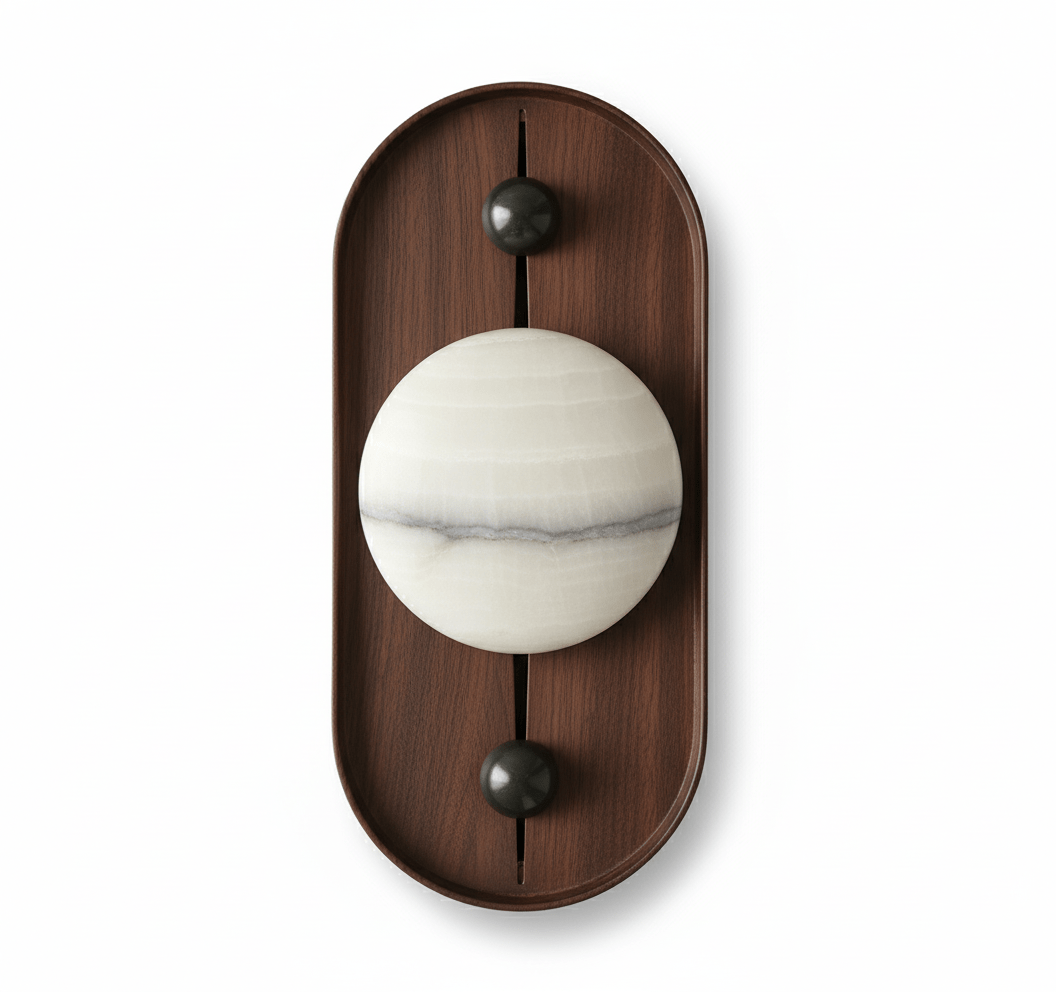 The oval Koyan wall light unlit, its alabaster globe crossed by a grey mineral band, on white.
