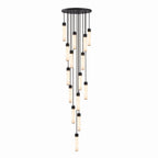 On a white background, a tall cascade of many black-capped alabaster tubes hangs from this Clérachic pendant.