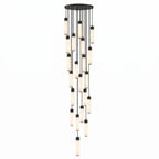 This Clérachic pendant's largest black-capped cluster cascades in a long, dense spiral of alabaster tubes on white.