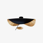 Curved steel disc ceiling light glowing warm overhead
