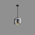 Smoked glass globe pendant light glowing softly above a modern interior