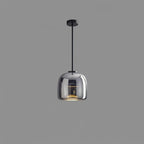 Smoked glass globe pendant light glowing softly above a modern interior