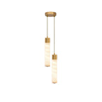 On a white background, this Clérachic pendant's two brass-capped alabaster tubes hang from a round brass plate.