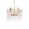 Copper-finish chandelier with clear glass shades glowing warmly above a dining table