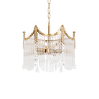 Copper-finish chandelier with clear glass shades glowing warmly above a dining table