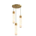 Three brass-capped alabaster tubes hang at different lengths from this Clérachic pendant's round brass ceiling plate.