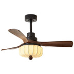 Shown unlit and at an angle against a white backdrop, this Clérachic ceiling fan's walnut blades and black motor housing stand out clearly.