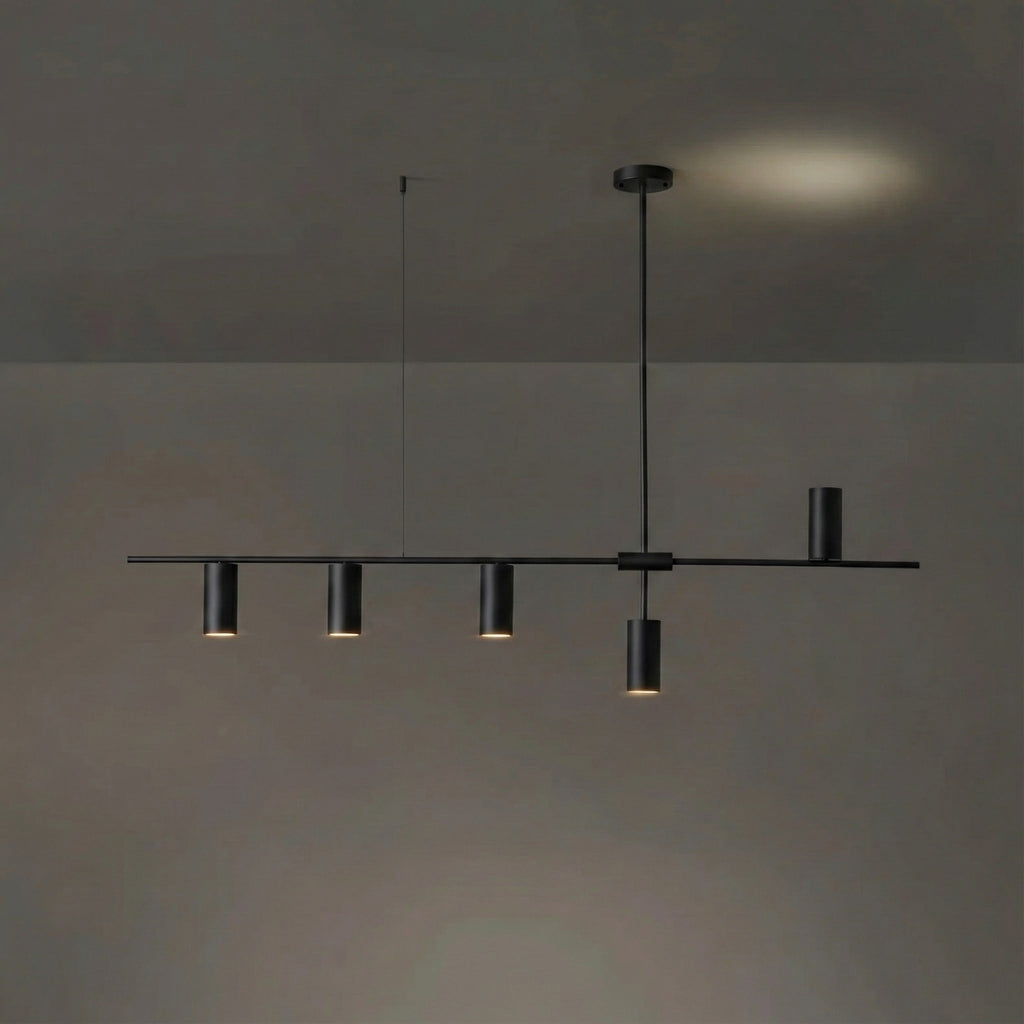 In the black finish, this Clérachic chandelier's rod and cylinder heads are uniformly dark, against a dim backdrop with a warm glow.
