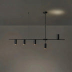 In the black finish, this Clérachic chandelier's rod and cylinder heads are uniformly dark, against a dim backdrop with a warm glow.