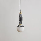 Marble and alabaster pendant lamp in black and white veined stone with brass fittings, shown unlit.