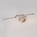 This nickel-finish Clérachic wall light glows above a two-door mirrored cabinet with open shelving and a small plant beside it.