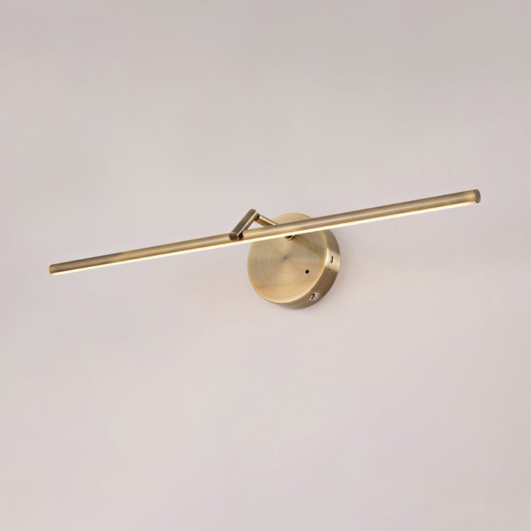 Angled view of this gold-finish Clérachic wall light on a plain wall, showing the offset bar and round canopy, unlit.