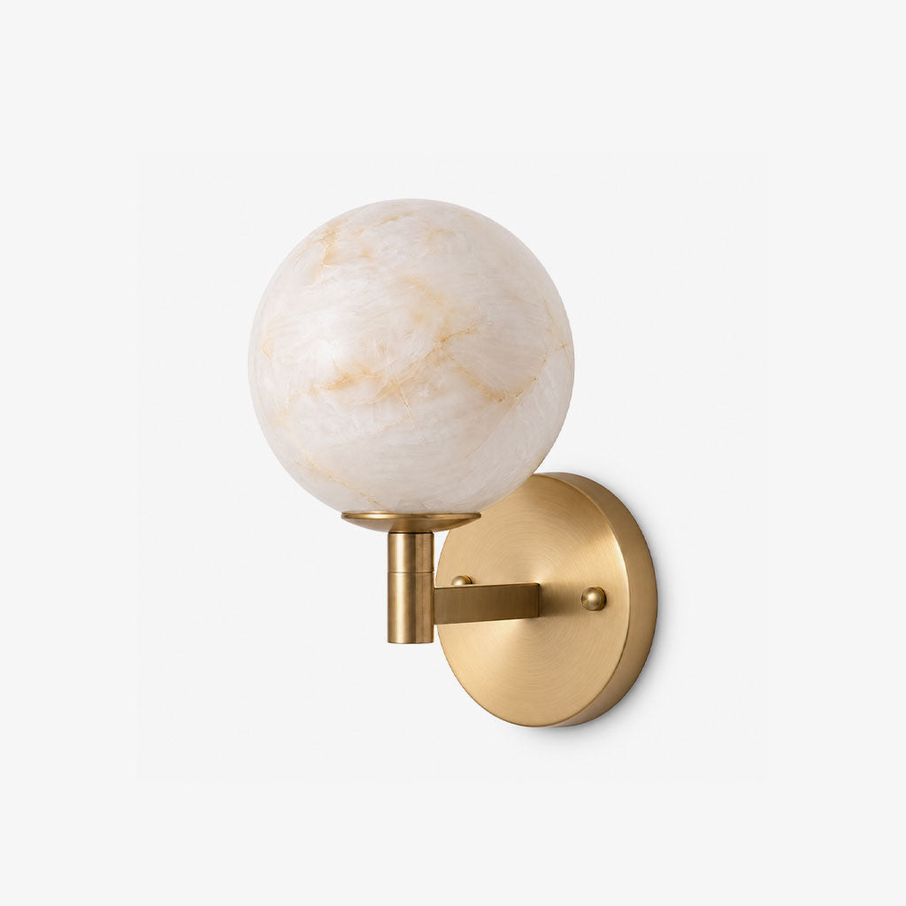 Cropped close on a plain background, this Clérachic sconce's brass arm curves upward to hold a single alabaster globe.