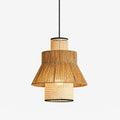This Clérachic pendant, its tiered rattan drums skirted in jute rope fringe, shown glowing against a plain background.