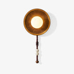 On white, this Clérachic wall sconce shows its full length, from the round shade to the wood and marble bead drop.