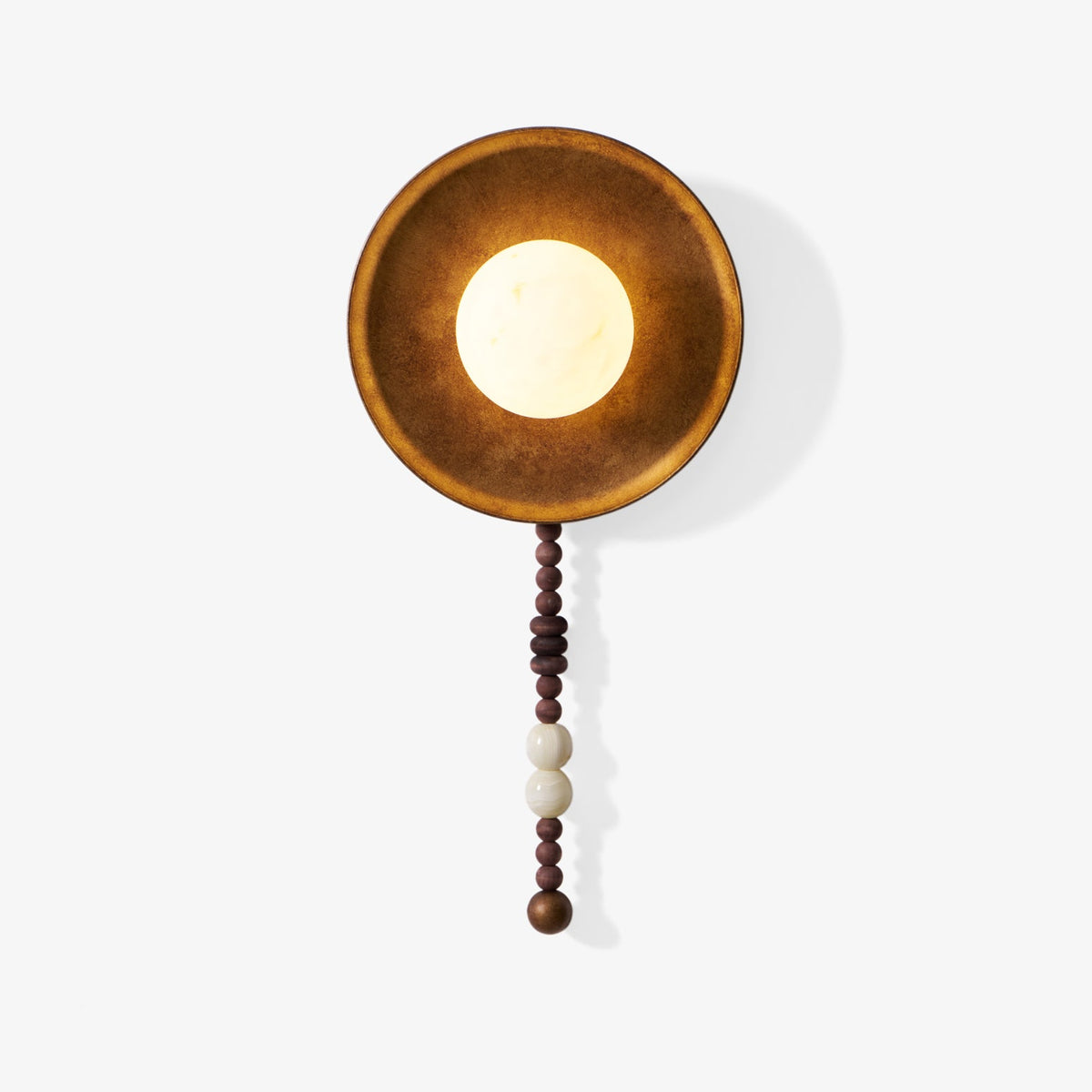 On white, this Clérachic wall sconce shows its full length, from the round shade to the wood and marble bead drop.