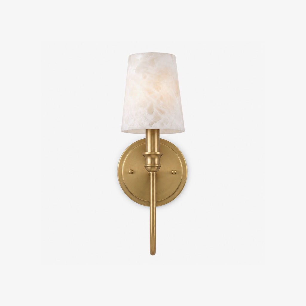Product view of this Clérachic sconce in brass hardware, its tapered alabaster cone shade glowing on a plain backdrop.