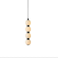 Orbique alabaster ball pendant light in its four-ball version, lit and hanging from a slim black cable