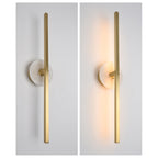 Clérachic wall light shown off and lit side by side, warm light spilling from its alabaster disc once switched on.