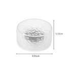 A clear textured glass container with dimension markings showing a height of 5.33cm and a diameter of 9.