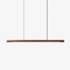 Wooden linear pendant light casting soft warm light in a room
