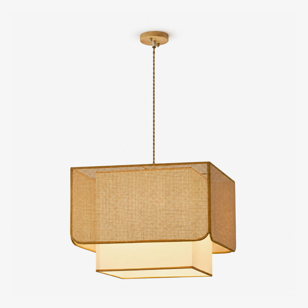 Product view of this Clérachic pendant's woven rattan lattice box shade sitting over a glowing fabric diffuser panel.