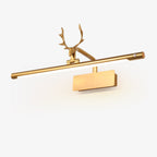 Stag horn wall sconce shining warm light onto a wall-hung painting