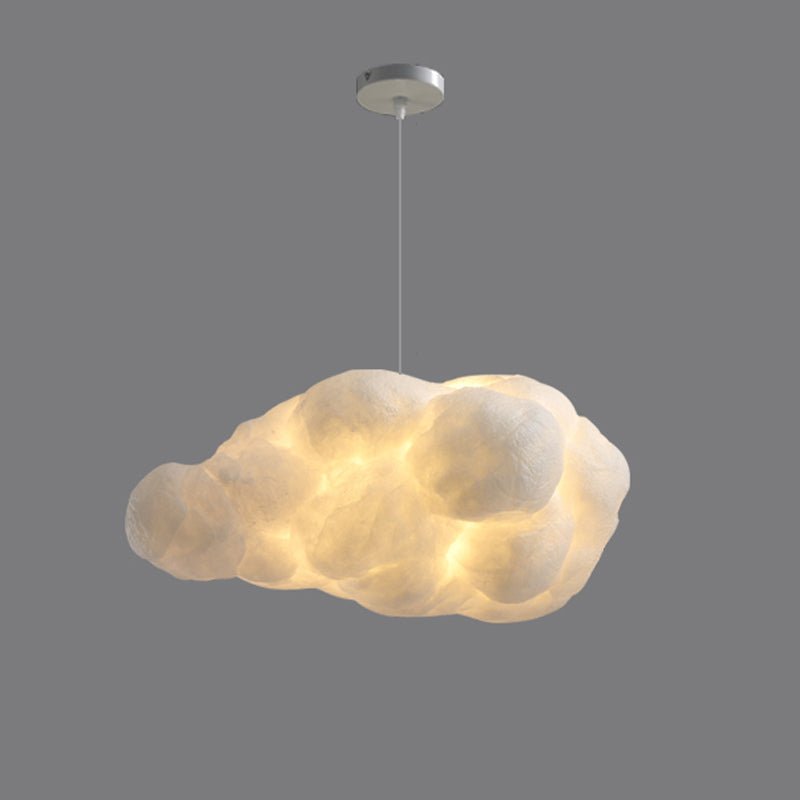Elongated and lit, this Clérachic cloud-shaped pendant glows against a darker grey backdrop.