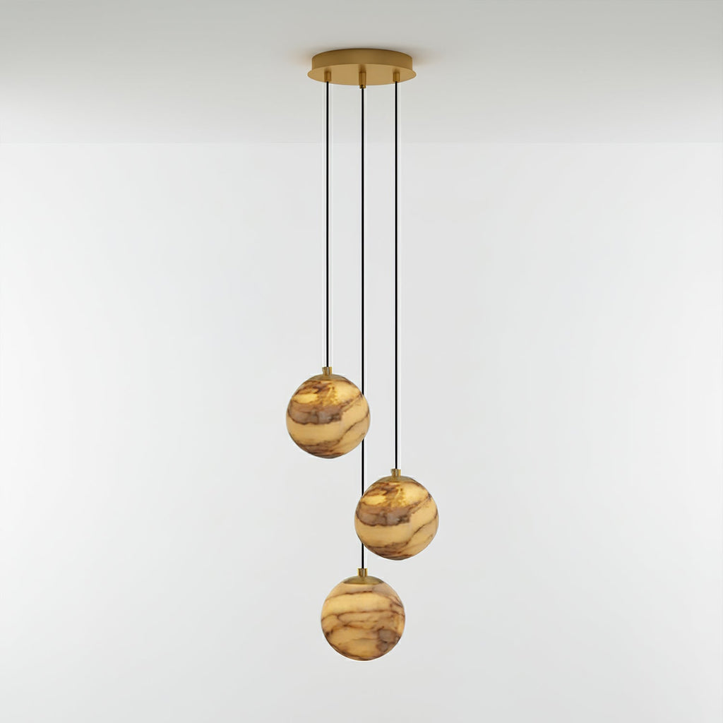 Three-light Sultana alabaster chandelier lit warm, its stone globes staggered below a round gold canopy.