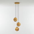 Three-light Sultana alabaster chandelier lit warm, its stone globes staggered below a round gold canopy.