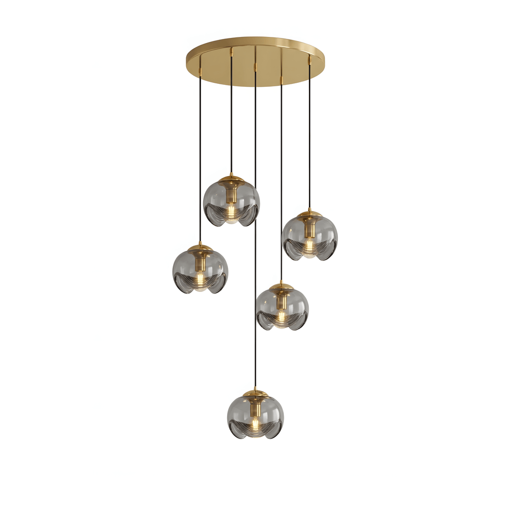 Six small round smoky grey glass shades hang at staggered heights from a gold ceiling plate, this Clérachic fixture shown on white.