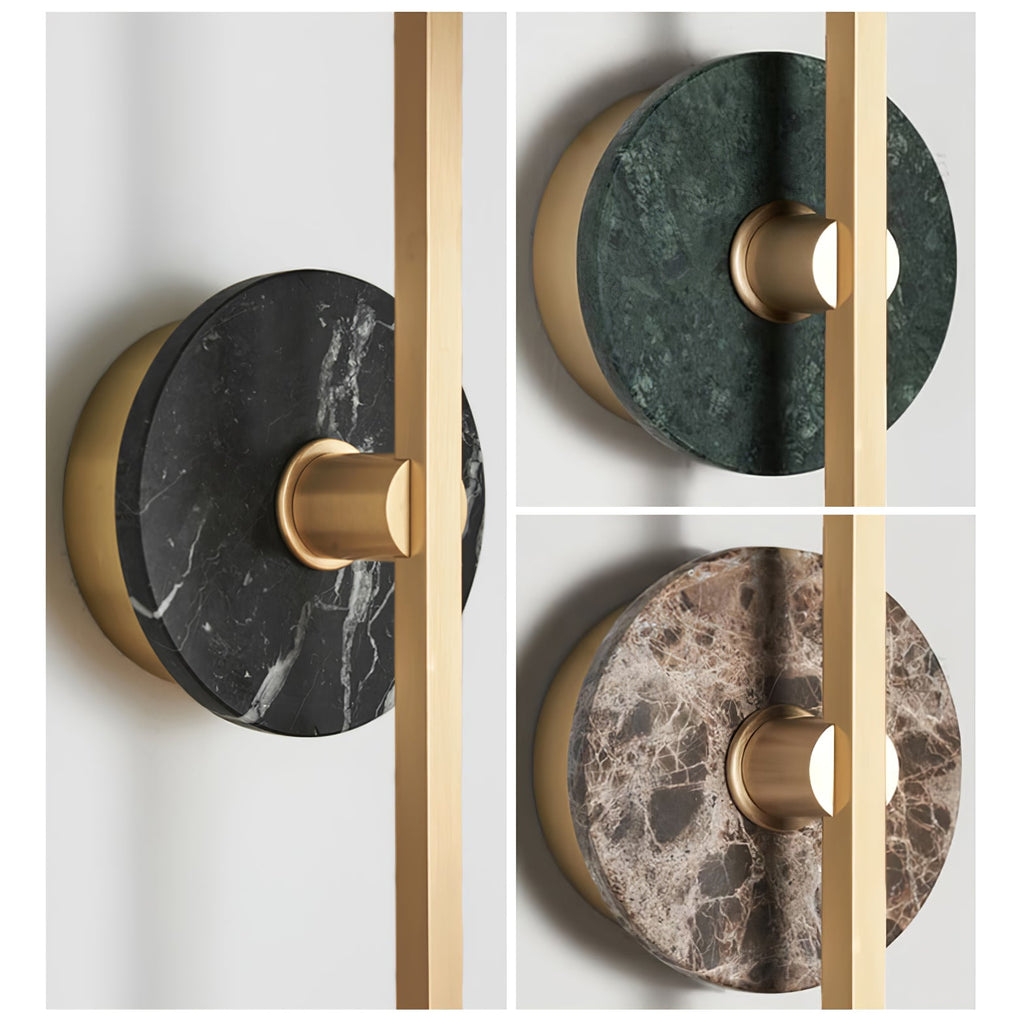 Three Clérachic wall sconce stone-disc finishes shown close together: dark, green and brown marble set on brass bars.