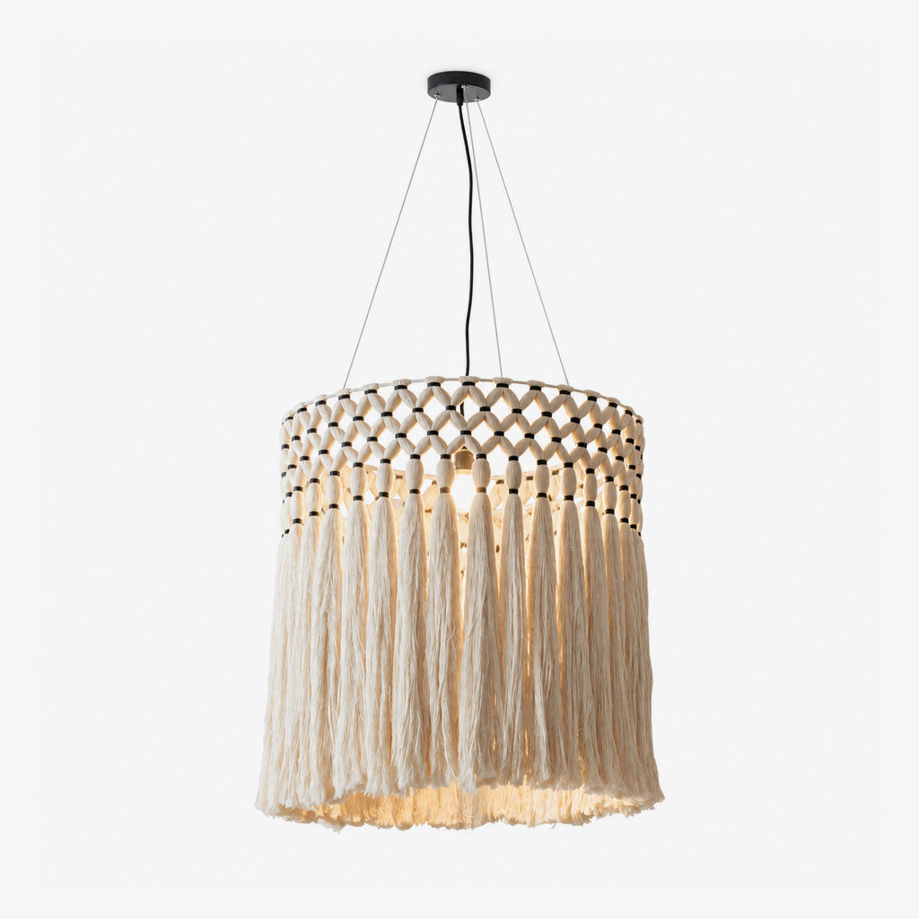 The hand-knotted diamond-lattice band and long cream fringe of this Clérachic pendant sit against a plain white backdrop.